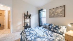 1 dormitorio con 1 cama con manta azul y blanca en Orlando getaway, en Orlando