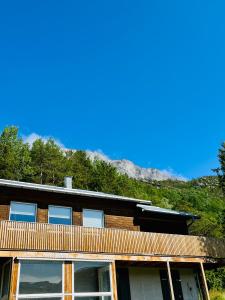 a house with a mountain in the background at Skjomen Lodge in Elvegård