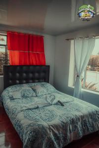 a bedroom with a bed and a window at Casa Campesina La Fagua in La Calera