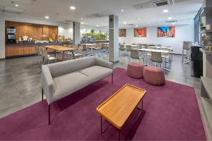 a living room with a couch and a table at City Express by Marriott San Luis Potosi Zona Industrial in San Luis Potosí