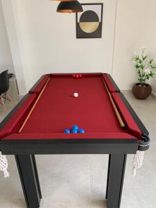 a pool table with a redsheet and balls on it at Pérola do Bessa in João Pessoa