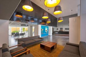 a lobby with couches and a table in a building at City Express by Marriott Matamoros in Matamoros