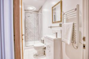 a white bathroom with a toilet and a shower at Suite 3 - 1 Bed Apartment King Size Bed in Lincoln