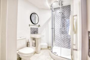 a white bathroom with a toilet and a shower at Suite 2- 2 Bed Apartment in Lincoln