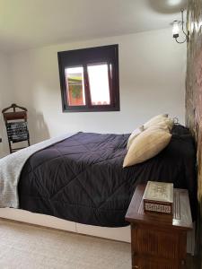 a bedroom with a bed and a window and a table at Casa Rural La CaTaTa in Las Lagunas