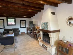 a living room with a stone fireplace at Casa Rural La CaTaTa in Las Lagunas