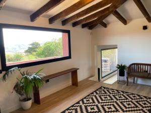 a living room with a large window and a rug at Casa Rural La CaTaTa in Las Lagunas