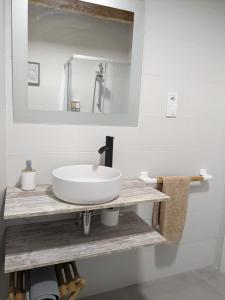 a bathroom with a white sink and a mirror at Montelobos 
