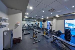 a gym with bikes and tread machines in a room at City Express Plus by Marriott Puerto Vallarta in Puerto Vallarta