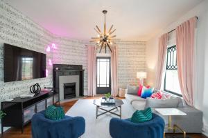 ein Wohnzimmer mit einem Sofa und einem Kamin in der Unterkunft Prime Walkable Location Spacious Home w Hot Tub in Nashville
