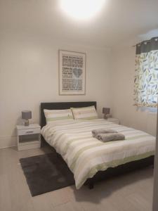 a bedroom with a large bed with two night stands at Heronsgate GH009 in Abbey Wood