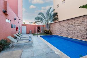 a swimming pool in the backyard of a building at City Express Junior by Marriott Merida Altabrisa in Mérida