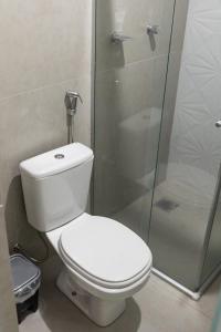 a bathroom with a toilet and a glass shower at Hotel Central in Boa Esperança