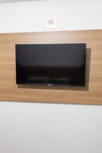 a flat screen tv sitting on top of a wall at Hotel Central in Boa Esperança +12 photos