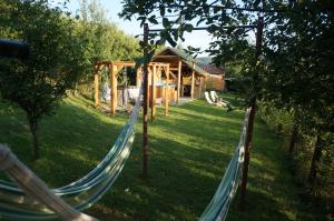 a hammock in a yard with a cabin at Natura Chalets in Praid