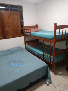 a room with two bunk beds and a door at Casa Souza in Ilhéus