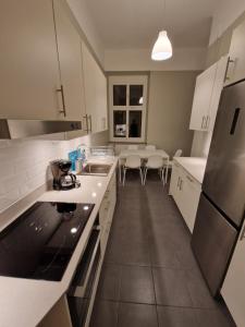 a kitchen with white cabinets and a counter top at Home Inn BRG15 in Stockholm