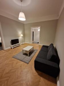 a living room with a couch and a table at Home Inn BRG15 in Stockholm