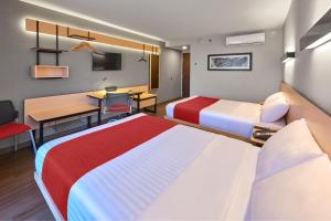 Postel nebo postele na pokoji v ubytování City Express by Marriott Tijuana Otay
