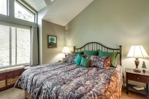a bedroom with a large bed with green pillows at Cozy Flagstaff Retreat with Fireplace and Gas Grill! in Flagstaff