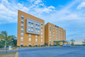 a large building with a car parked in a parking lot at City Express by Marriott Salamanca in Salamanca