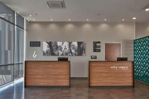 a lobby with a reception desk in a building at City Express by Marriott La Raza in Mexico City