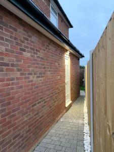 a brick building with a door on the side of it at Charming 1-Bedroom Retreat for up to 4 Guests in Windsor