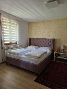 a bedroom with a bed and a window at Apartman "EXCLUSIVE" in Bihać