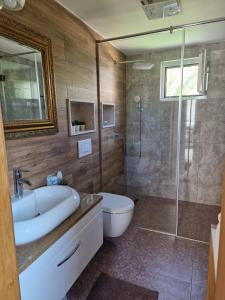 a bathroom with a tub and a sink and a shower at Apartman "EXCLUSIVE" in Bihać
