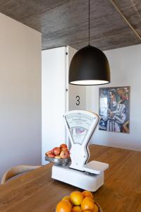 a scale sitting on top of a table with fruit at Columbano Suites Accomodations Lisboa - Praça de Espanha, Sete Rios - Bookable parking in Lisbon