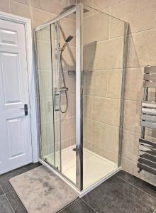 a shower with a glass enclosure in a bathroom at lfracombe Holiday Apartment Close to Tunnels Beaches in Ilfracombe