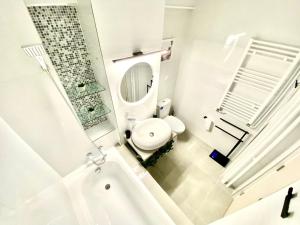 a white bathroom with a toilet and a sink at Union Experience - City Center in Timişoara +23 photos