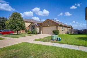 a house with a car parked in the driveway at Family-Friendly Killeen Home with Covered Patio! in Killeen