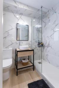 a white bathroom with a sink and a mirror at Apartamento tranquilo y céntrico en Santander in Santander +17 photos