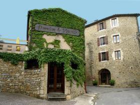 a building with ivy growing on the side of it at La Vieille Tour in Salavas
