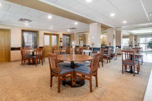 a dining room with wooden tables and chairs at Best Western Rocky Mountain House Inn & Suites in Rocky Mountain House