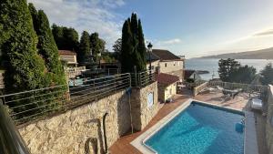 a house with a swimming pool and a view of the water at Casa Abuela Julia in Poio