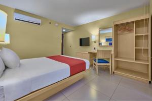 a hotel room with a bed and a desk at City Express by Marriott Campeche in Campeche