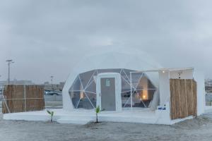 a small white building with a glass dome on the beach at AVICENNIA BEACH DOMES in Salalah