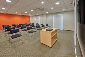 a conference room with a row of chairs and a podium at City Express by Marriott Saltillo Sur in Saltillo