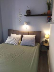 a bedroom with a bed with two pillows on it at KORA Piraiki in Piraeus
