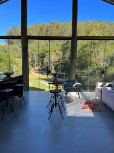 a living room with a table and a couch at Recanto Tereza Dias in Lagoinha