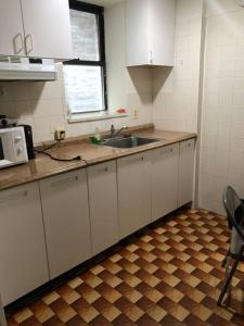 a kitchen with a sink and a microwave at 1C CLOSe in New York