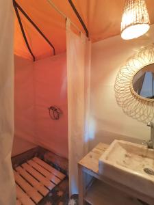 a bathroom with a sink and a mirror at Jardin Kotori Luxury Camp in Merzouga
