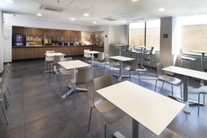 a restaurant with tables and chairs and a counter at City Express by Marriott Piedras Negras in Piedras Negras