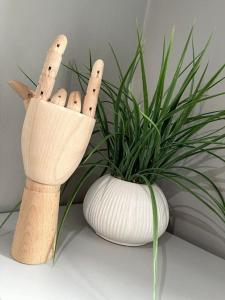 a vase with a bunch of sticks in it next to a plant at Studio Apartment In Brighton & Hove in Brighton & Hove