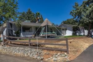 a house with a tent in the front of it at 5208 Pine Street in Mariposa