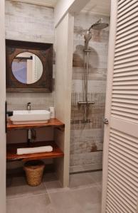 a bathroom with a sink and a mirror at o'Filao in Grand-Bourg