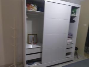 a white cabinet with a mirror in a room at Casa na praia de maresias em condomínio na avenida da praia com piscina aquecida in Maresias