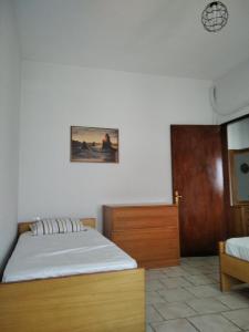 a bedroom with a bed and a wooden cabinet at Labyrinthos Apartments in Ierissos
